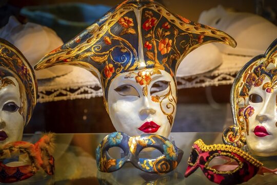 Venetian carnival masks in a shop window, Venice, Veneto, Italy