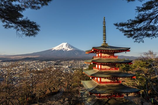 Five-storey pagoda, Chureito Pagoda, with views over Fujiyoshida City and Mount Fuji volcano at morning sun, Yamanashi Prefecture, Japan