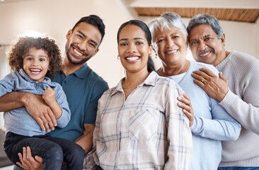Obraz premium Portrait, generations and parents with child with hug, bonding and love in home living room. Big family, mom and dad with boy and grandparents smile for weekend break, support and comfort with trust