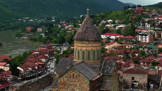 Cinematic aerial drone footage of the historic Svetitskhoveli Cathedral located in Mtskheta. One of the most important Orthodox landmarks in Georgia, surrounded by scenic landscapes 