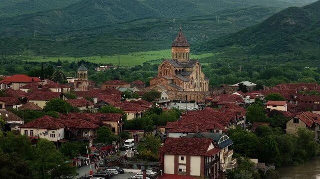 Cinematic aerial drone footage of the historic Svetitskhoveli Cathedral located in Mtskheta. One of the most important Orthodox landmarks in Georgia, surrounded by scenic landscapes 
