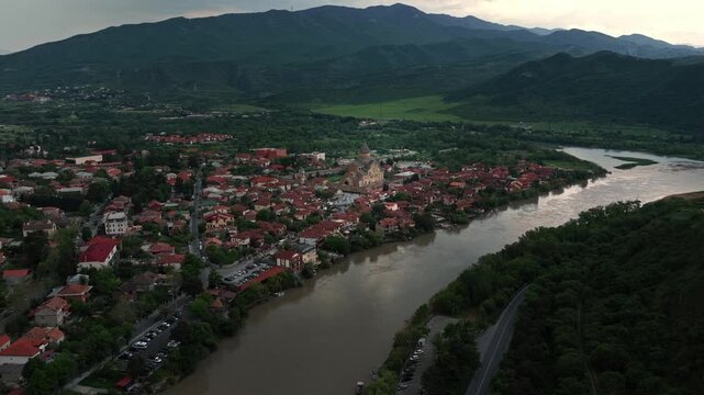 Cinematic aerial drone footage of the historic Svetitskhoveli Cathedral located in Mtskheta. One of the most important Orthodox landmarks in Georgia, surrounded by scenic landscapes 