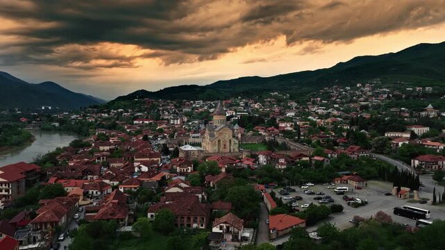 Cinematic aerial drone footage of the historic Svetitskhoveli Cathedral located in Mtskheta. One of the most important Orthodox landmarks in Georgia, surrounded by scenic landscapes 