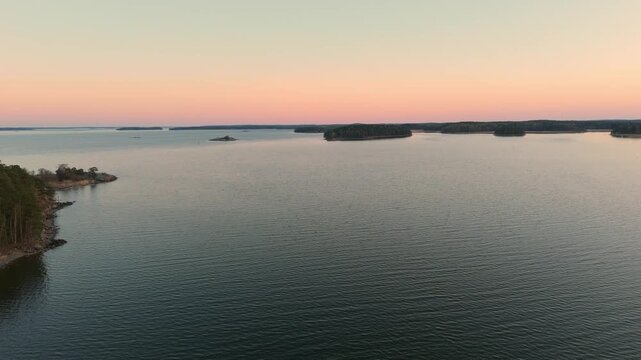 Aerial Drone Reveal: Rising over the Sea to Turku Archipelago and Ruissalo Island at Golden Hour