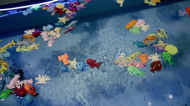 Small toys floating in a water tank. Close-up shooting