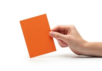 Obraz premium Hand holding a bright orange card against white background isolated on white background