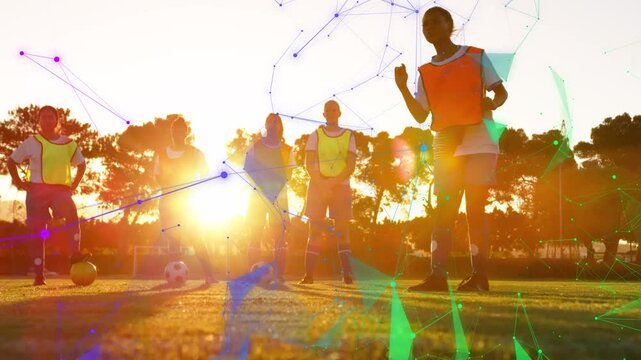 Team waiting orange player dribbling ball training feint with pulsing polygons over team for sports