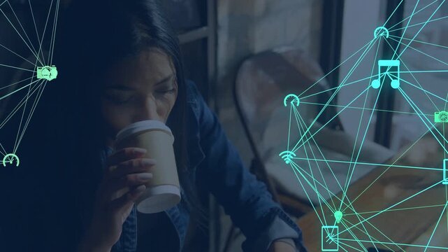 Woman sipping coffee glancing at device lowering cup typing working teal tech icons animating right