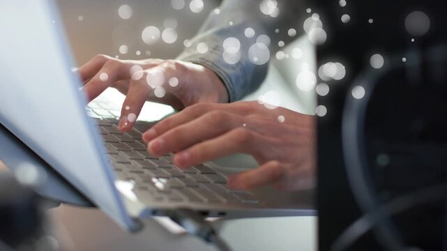 Man typing on laptop at desk, pressing keys causing growing bokeh overlay while editing tech report