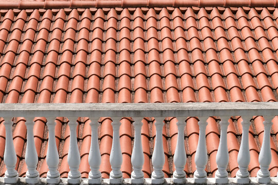 Terracotta roof tiles and white balustrade detail