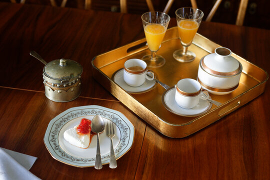 Breakfast tray with coffee and orange juice with antique tableware 