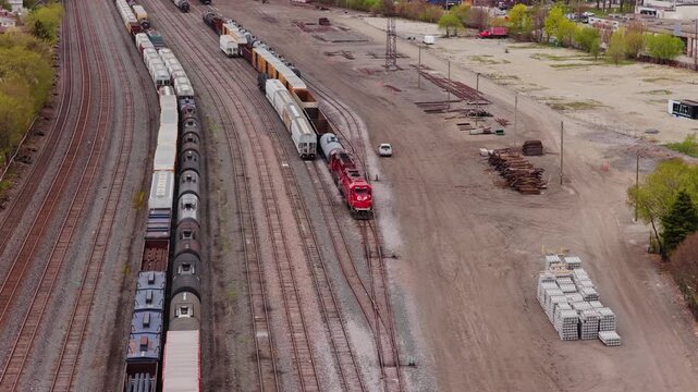Canadian Pacific Kansas City freight train locomotive maneuvering in railway yard connecting cargo wagons and preparing for intermodal container transportation