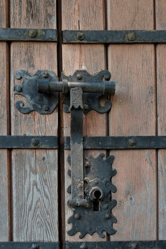 Antique iron door latch on weathered wooden door