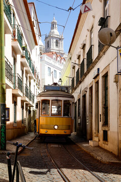 Famous yellow 28  tram on narrow Lisbon street
