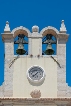 Twin bells on a whitewashed clock tower