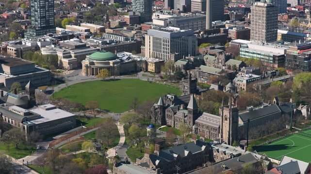 University of Toronto campus revealing King's College Circle, Convocation Hall, University College building with downtown Toronto urban cityscape background