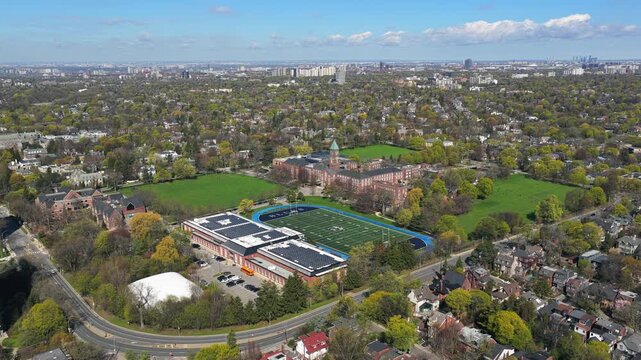 Upper Canada College campus appearing in Forest Hill, Toronto, surrounded by expansive urban green spaces and residential neighborhoods from unique tripod aerial perspective