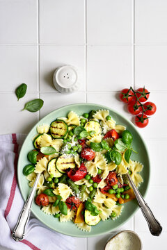 Traditional italian pasta primavera with spring vegetables. Top view with copy space.