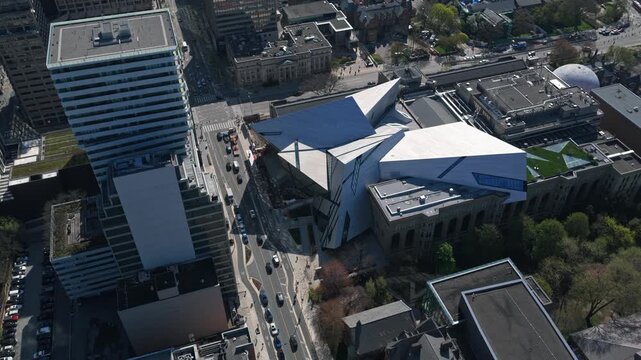 Royal Ontario Museum's modern deconstructivism architecture in Toronto, Ontario with city streets and traffic moving below on a sunny day in Canada
