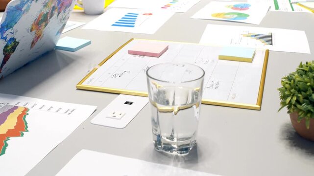 Top-down view of creative team brainstorming with charts and coffee in modern office video footage