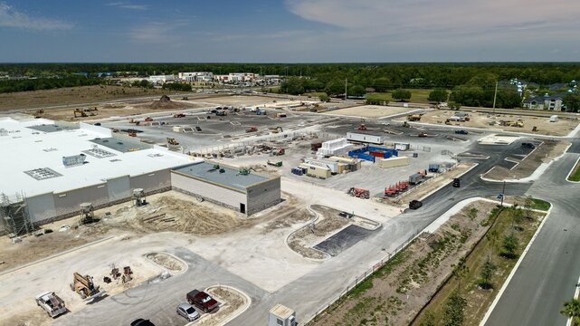 Aerial view of the construction site at Foundry Lane with heavy machinery and a large white building under development World Golf Village, Florida, United States.