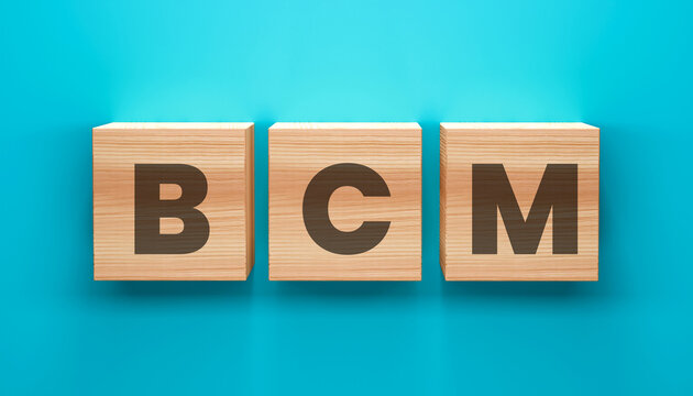 BCM Blocks: Three wooden blocks, neatly arranged, spell out the letters BCM against a vibrant backdrop, symbolizing a foundation for business continuity. 
