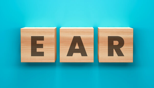 EAR Wooden Cubes on Teal Backdrop: Three wooden cubes, each emblazoned with a letter to spell EAR, rest against a backdrop of teal. this conceptual image.
