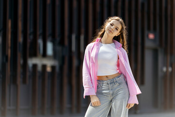 Fototapeta premium Young woman posing in casual street fashion style