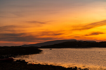 Naklejka premium Sunset view of Clew Bay near Westport, County Mayo, Ireland. Scenic orange evening light over the Atlantic inlet and mountains on the Wild Atlantic Way.