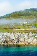 Naklejka premium Misty White Cliffs of Ashleam on Achill Island, County Mayo, Ireland. Dramatic Atlantic sea cliffs and turquoise water on the Wild Atlantic Way.