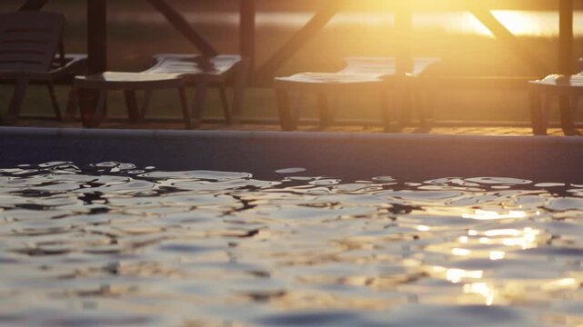 Top view of swimming pool with clear water on vacation on sunset background