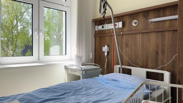 Ward in the postpartum department of the maternity hospital in Vyshkov. Czech Republic. Baby cot with breath monitor and bed for mom