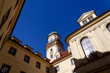 Fototapeta premium Astronomical Tower of the Klementinum in Prague with Atlant statue holding heavens, Czech Republic, clear blue sky, sunny day