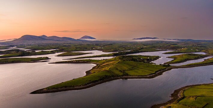 Aerial sunset view over Clew Bay near Westport, County Mayo, Ireland. Scenic Atlantic bay with drumlin islands and mountain silhouettes on the Wild Atlantic Way.