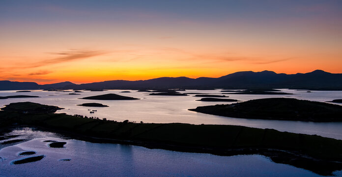 Aerial sunset view over Clew Bay near Westport, County Mayo, Ireland. Scenic Atlantic bay with drumlin islands and mountain silhouettes on the Wild Atlantic Way.
