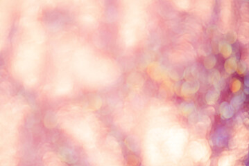 Fototapeta premium Defocus light background pink with yellow. Blurred sparkles
