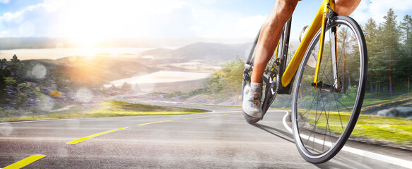 Fototapeta premium Cycling. A captivating shot of a helmeted biker riding along an asphalt road. Cycling competitions. Active recreation. Sport. Professional road bicycle racer close up view