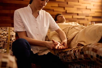 Fototapeta premium Close up of spa client receiving relaxing hand massage in wellness center.