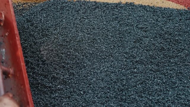 Leveling rubber crumb mixture with hand screed close up
