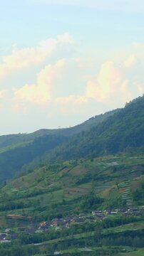 Vertical Video Mount Merapi Mountain View with Mount Merapi Foothill Village, Mount Merapi Terraced Farmland, Serene Morning Mist Landscape, Panning 