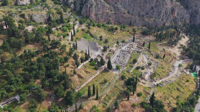 Majestic aerial perspective showing the ancient theatre and the temple of Apollo at the archaeological site of Delphi. A Unesco world heritage site nestled on the slopes of mount Parnassus in Greece