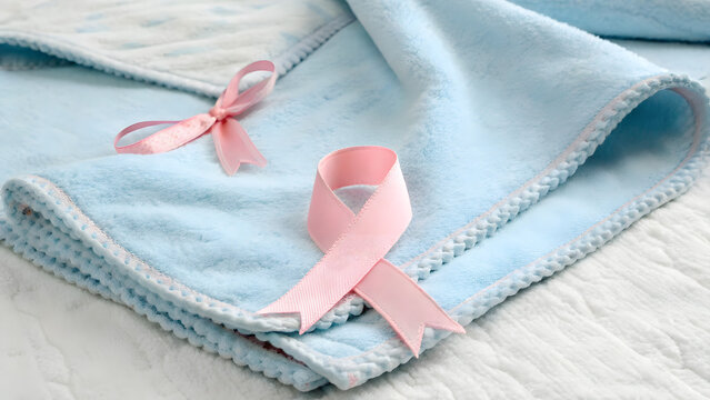 Pink Ribbon on a Blue Blanket Promoting Birth Defect Awareness