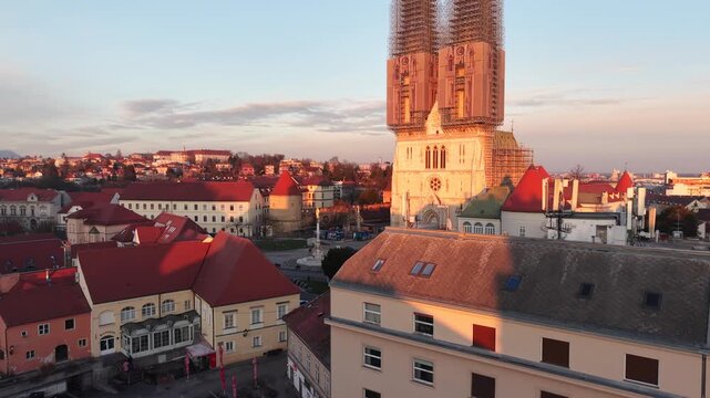 Aerial view of Zagreb Cathedral and the historic Kaptol district. Cinematic drone shot of the Gothic spires and the medieval walls of the Cathedral of the Assumption of the Blessed Virgin Mary in Croa