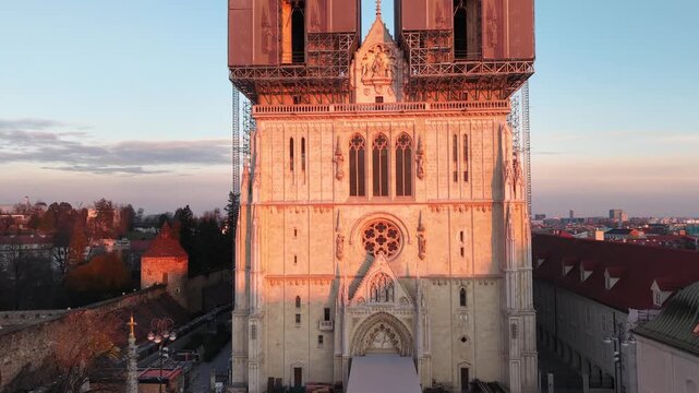 Aerial view of Zagreb Cathedral and the historic Kaptol district. Cinematic drone shot of the Gothic spires and the medieval walls of the Cathedral of the Assumption of the Blessed Virgin Mary in Croa