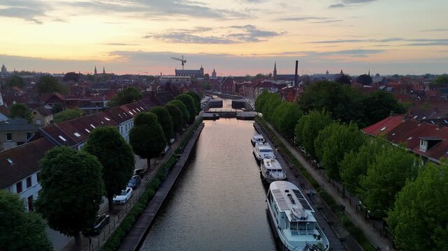 Aerial View of Canal Boats and Historic Architecture in Bruges Belgium at Sunset