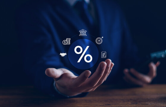 Businessman hold percentage icon symbols banking, target goals, financial reports, partnerships, revenue. company interest rates, profit optimization, dividend growth, strategic financial management.