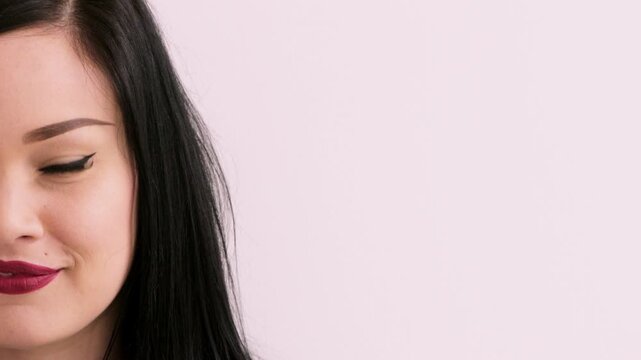 Space, makeup and face of woman in studio for cosmetics, advertisement and beauty promotion. Cosmetology, salon and portrait of half person with red lipstick, mascara and makeover on white background