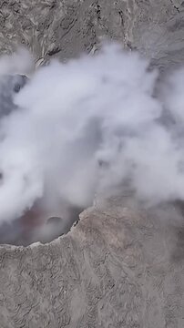 Erta Ale volcano Danakil Depression Ethiopia, eruption. Aerial view in vertical video.
