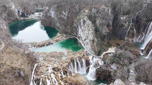 Aerial view of the stunning waterfalls and turquoise lakes in Plitvice Lakes National Park. Cinematic drone shot of the UNESCO World Heritage site in Croatia