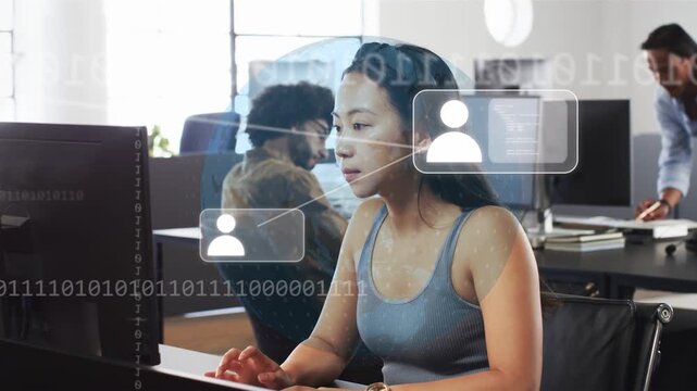 Woman typing at keys in business office, spawning HUD icons and bit stream indicating network alert
